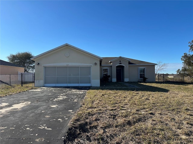 ranch-style home with a garage and a front lawn