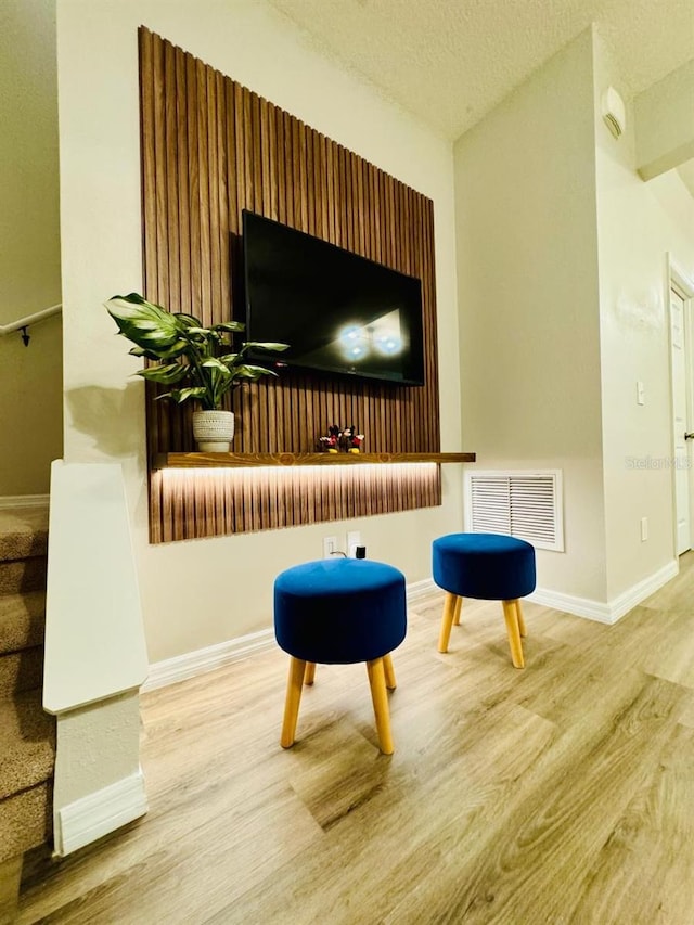 sitting room featuring hardwood / wood-style floors and a textured ceiling