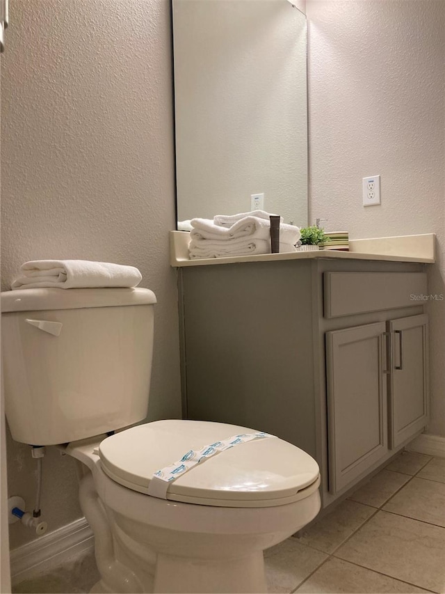 bathroom featuring tile patterned floors, vanity, and toilet