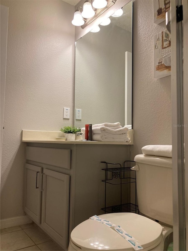 bathroom with tile patterned floors, vanity, and toilet