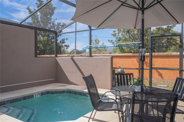 view of swimming pool featuring a lanai and a patio