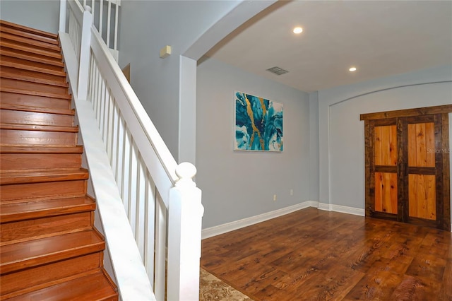 foyer entrance featuring dark wood-type flooring