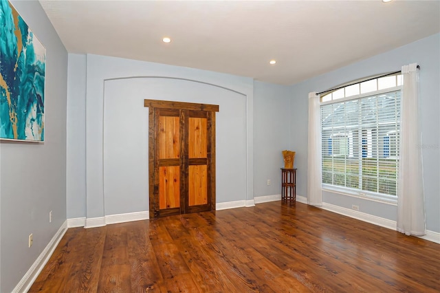 spare room with dark hardwood / wood-style floors