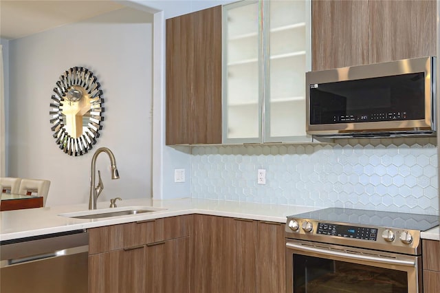 kitchen featuring backsplash, sink, and stainless steel appliances