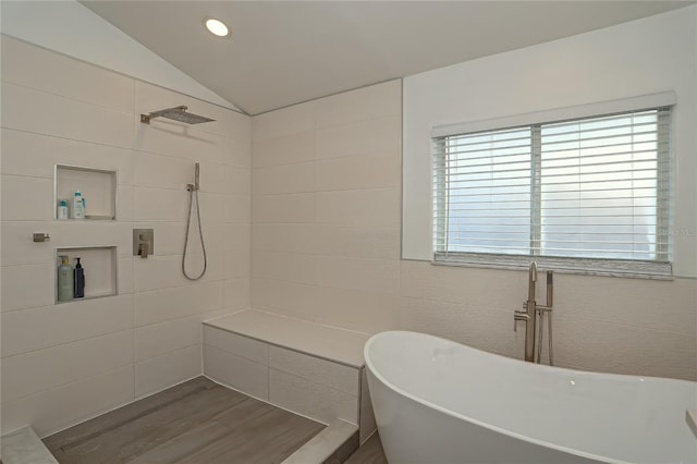 bathroom featuring hardwood / wood-style floors, lofted ceiling, and shower with separate bathtub