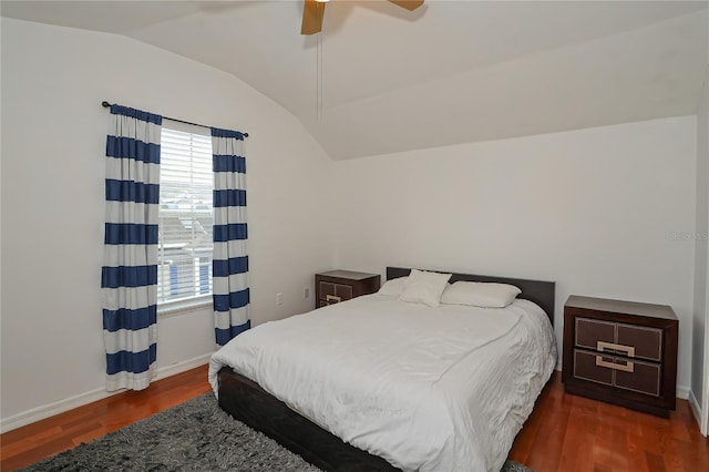 bedroom with ceiling fan, dark hardwood / wood-style floors, and vaulted ceiling