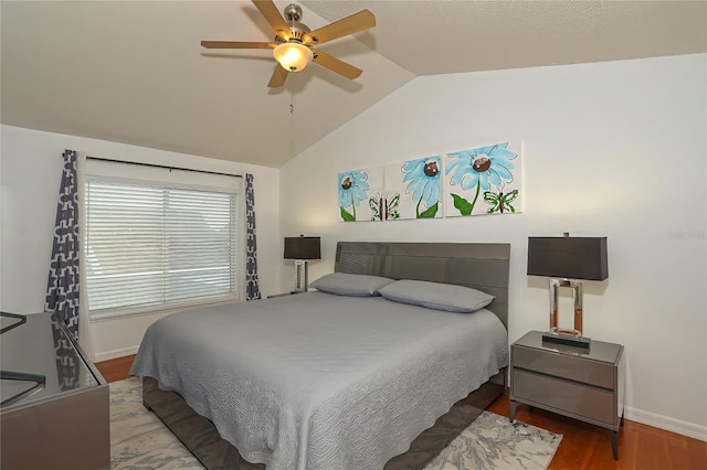 bedroom featuring hardwood / wood-style flooring, ceiling fan, and lofted ceiling