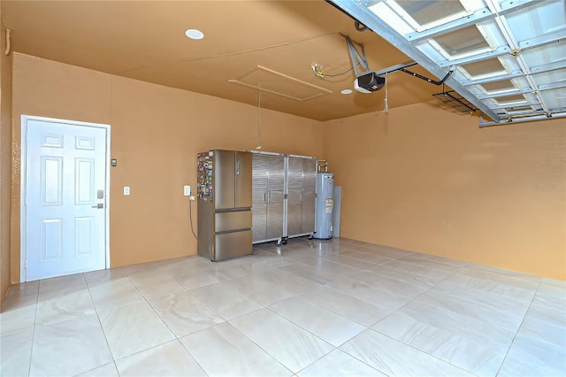 garage with a garage door opener, stainless steel refrigerator, and water heater