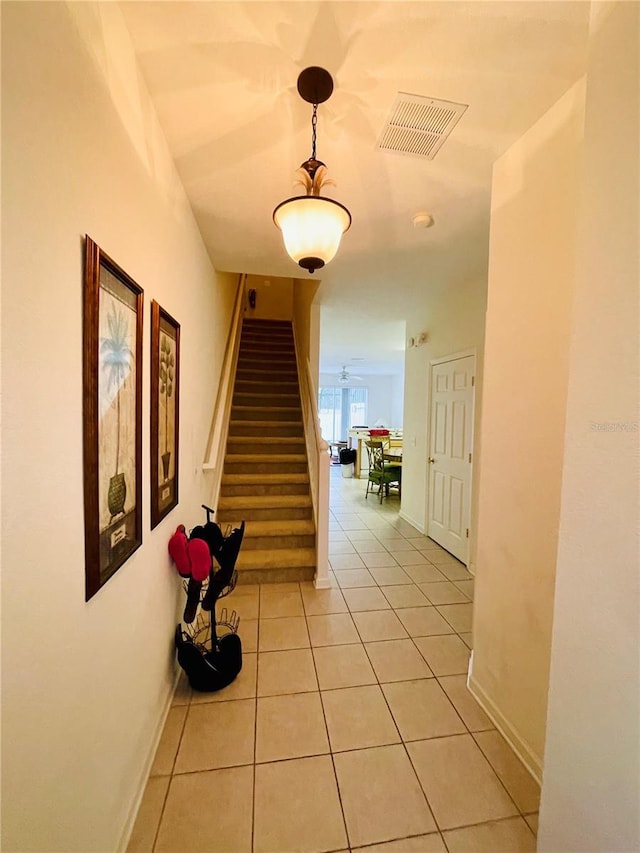 hall with light tile patterned floors