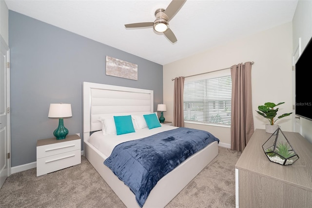 bedroom featuring light colored carpet and ceiling fan