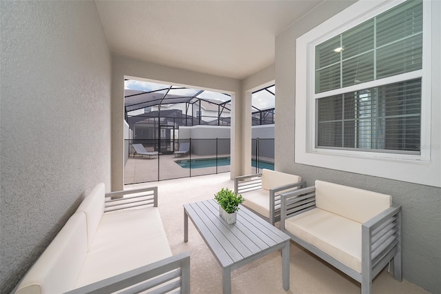 view of patio featuring glass enclosure and an outdoor hangout area