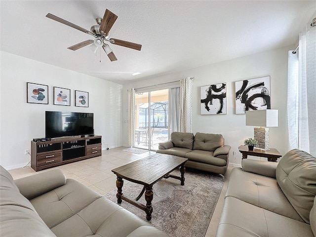 tiled living room with ceiling fan and a textured ceiling