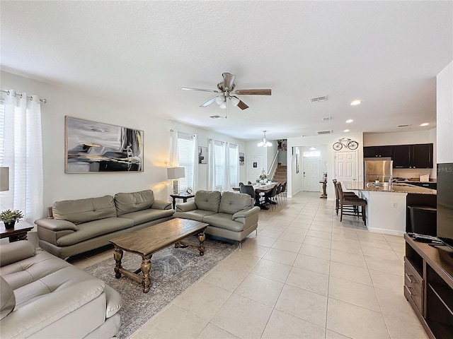 living room featuring ceiling fan, light tile patterned floors, and a healthy amount of sunlight