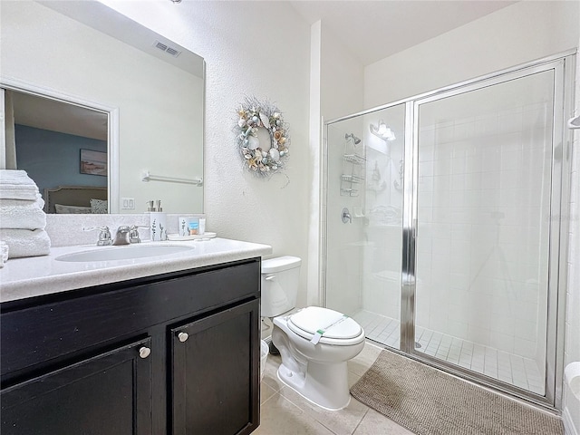 bathroom with toilet, tile patterned floors, an enclosed shower, and vanity