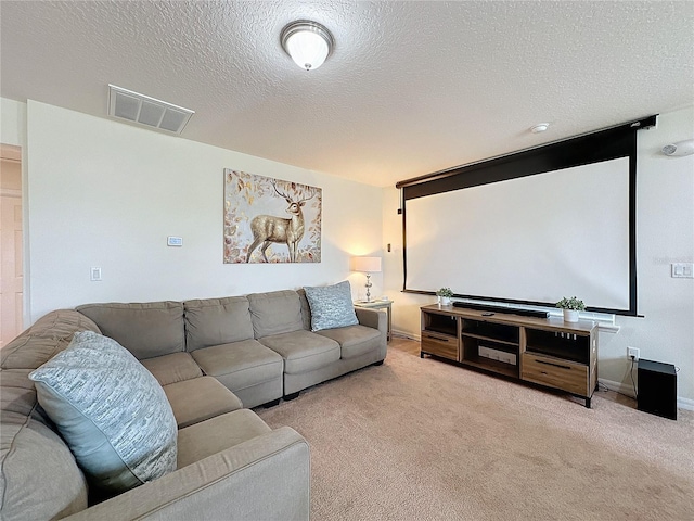 carpeted home theater room featuring a textured ceiling