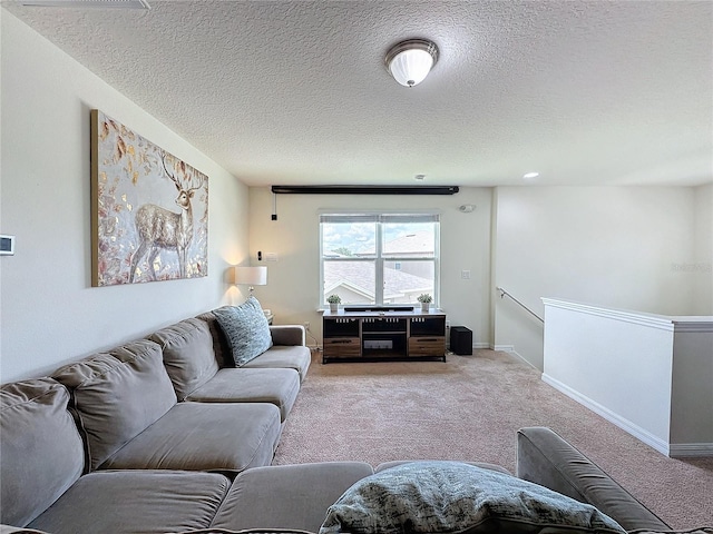 carpeted living room with a textured ceiling