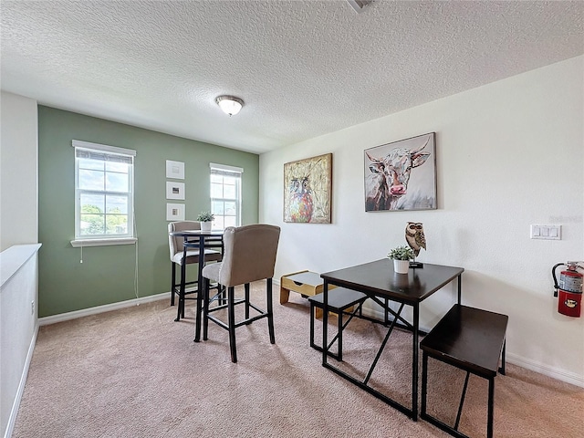 carpeted home office with a textured ceiling