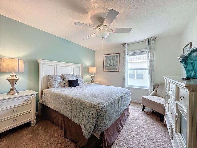 carpeted bedroom with ceiling fan, a textured ceiling, and vaulted ceiling