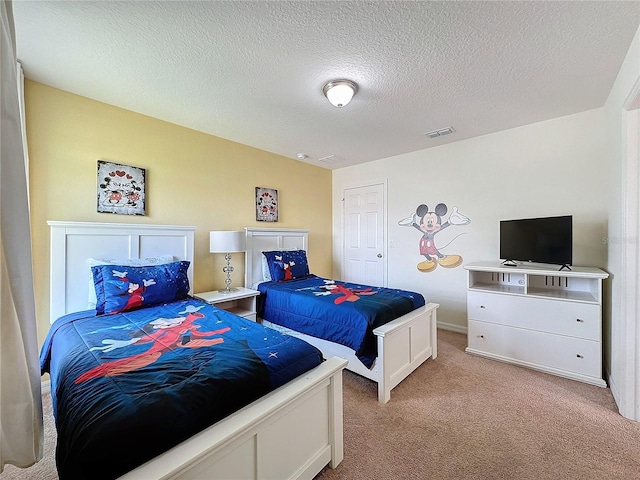 carpeted bedroom featuring a textured ceiling