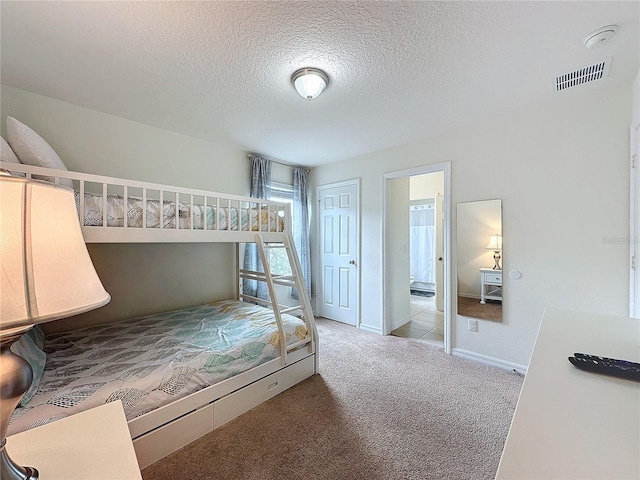 bedroom with light carpet, a closet, and a textured ceiling