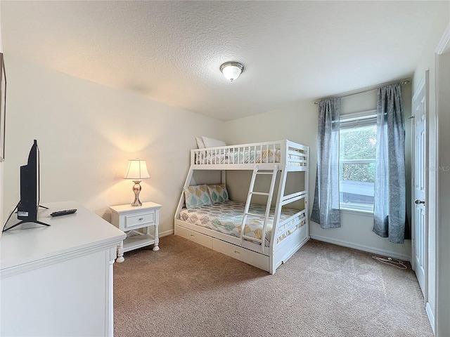 carpeted bedroom featuring a textured ceiling