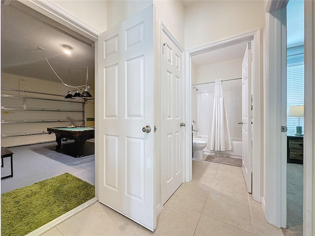 hall featuring light tile patterned flooring