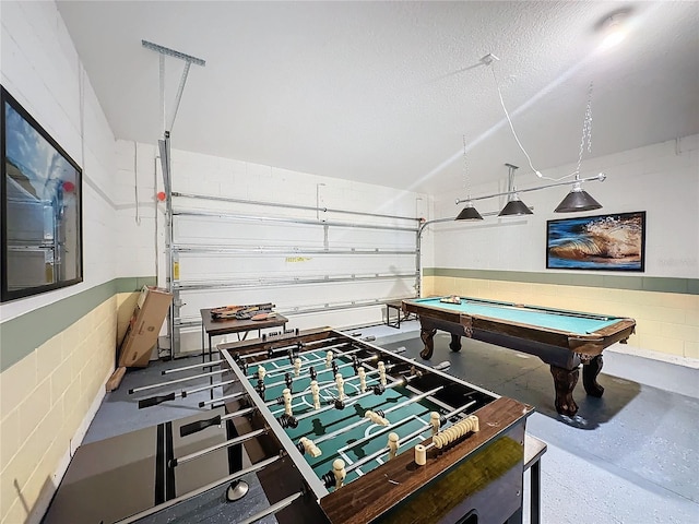 playroom featuring pool table and a textured ceiling