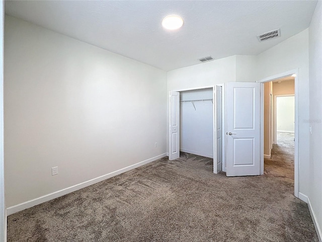 unfurnished bedroom with a closet and carpet floors