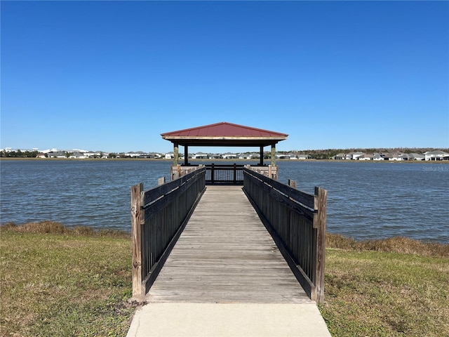 view of dock featuring a gazebo and a water view