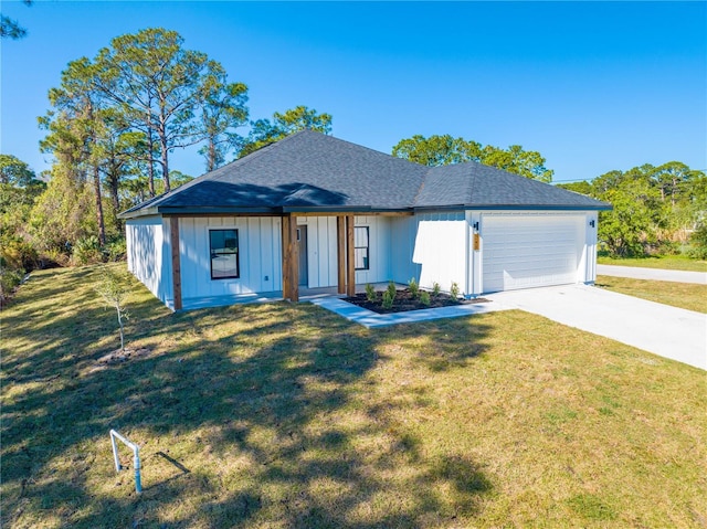 view of front of property with a front lawn and a garage