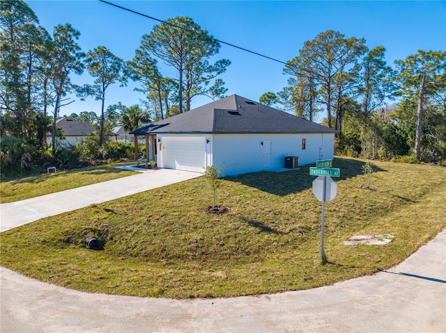 view of property exterior with a garage, a lawn, and central air condition unit