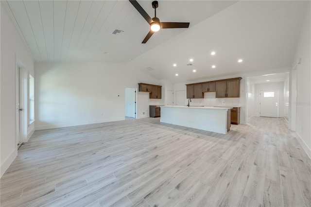 kitchen with light hardwood / wood-style floors, a center island with sink, ceiling fan, and a healthy amount of sunlight