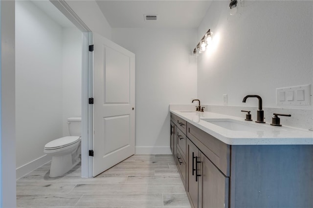 bathroom with toilet and vanity