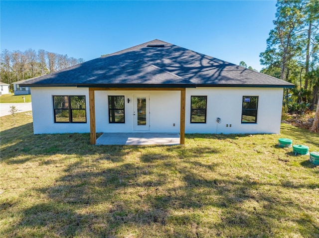 back of property with a patio area and a yard