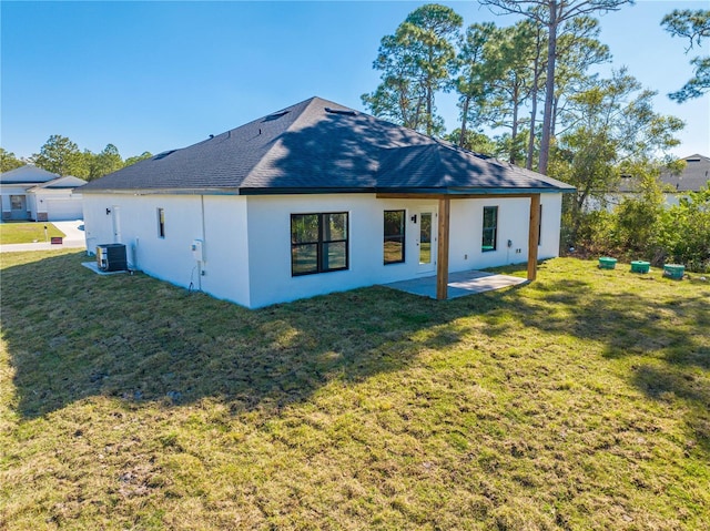 back of property with a patio area, central AC unit, and a lawn