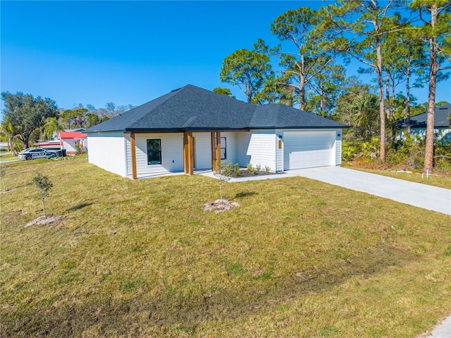 view of front of property featuring a garage and a front yard