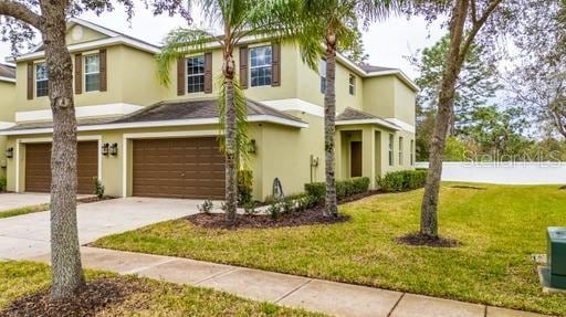 view of front of home with a front lawn and a garage