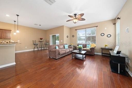 living room with ceiling fan and dark hardwood / wood-style floors