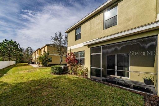 rear view of house featuring a lawn