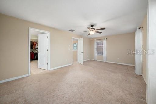 unfurnished bedroom featuring ceiling fan and light colored carpet