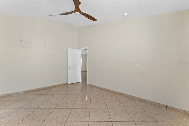 spare room with ceiling fan and light tile patterned floors