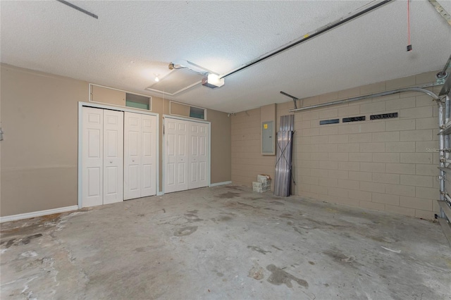 garage with electric panel and a garage door opener