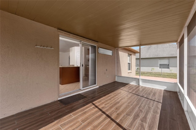 unfurnished sunroom featuring wooden ceiling