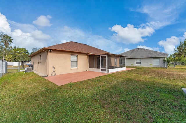 rear view of property with central air condition unit, a sunroom, a yard, and a patio