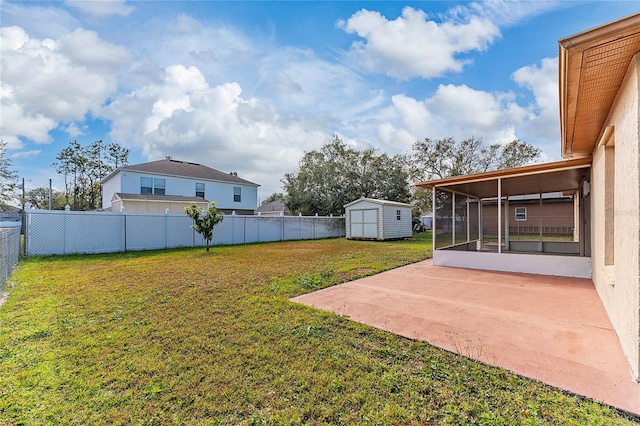 view of yard with a patio area, a sunroom, and a shed