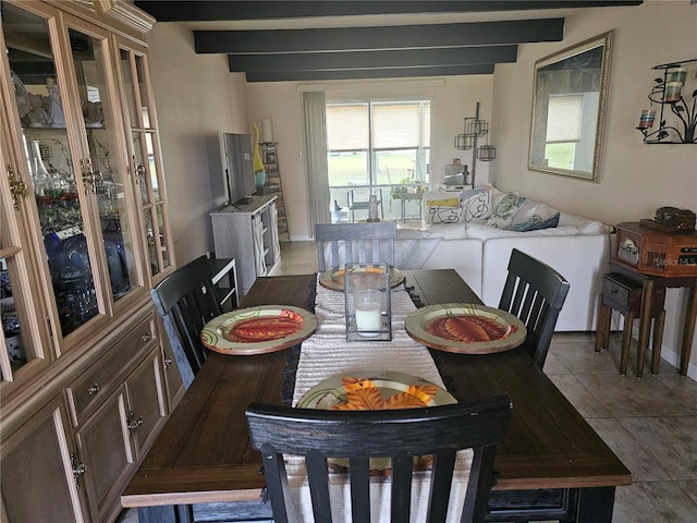 tiled dining room with beamed ceiling