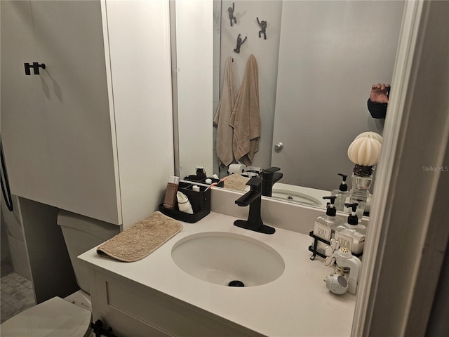 bathroom featuring vanity and toilet