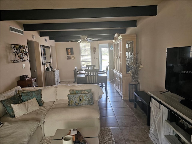 tiled living room with ceiling fan and beamed ceiling