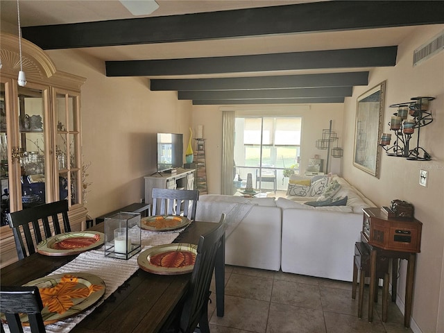 tiled dining room with beam ceiling