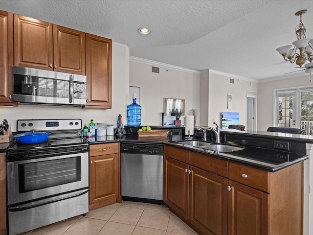 kitchen with crown molding, appliances with stainless steel finishes, sink, and a textured ceiling